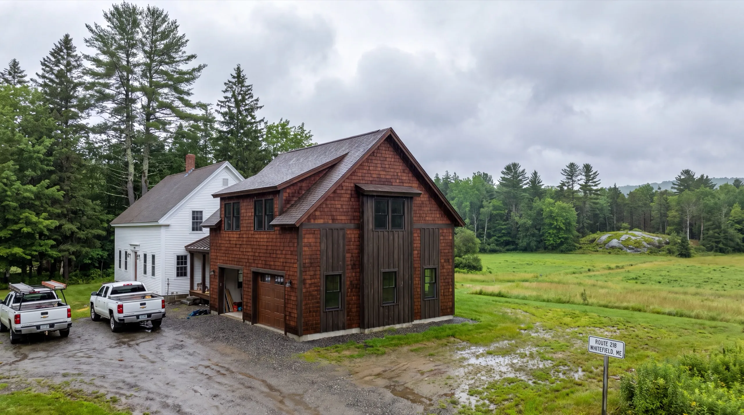General contractor in Whitefield, ME: finished cedar-shingled garage wing with rooms above joined to a white farmhouse